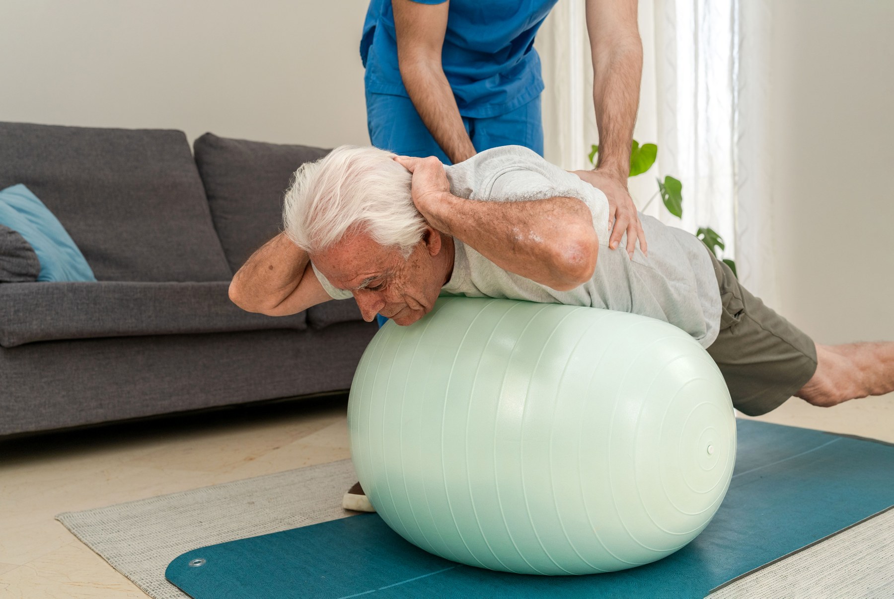 An older adult receiving physiotherapy support at home