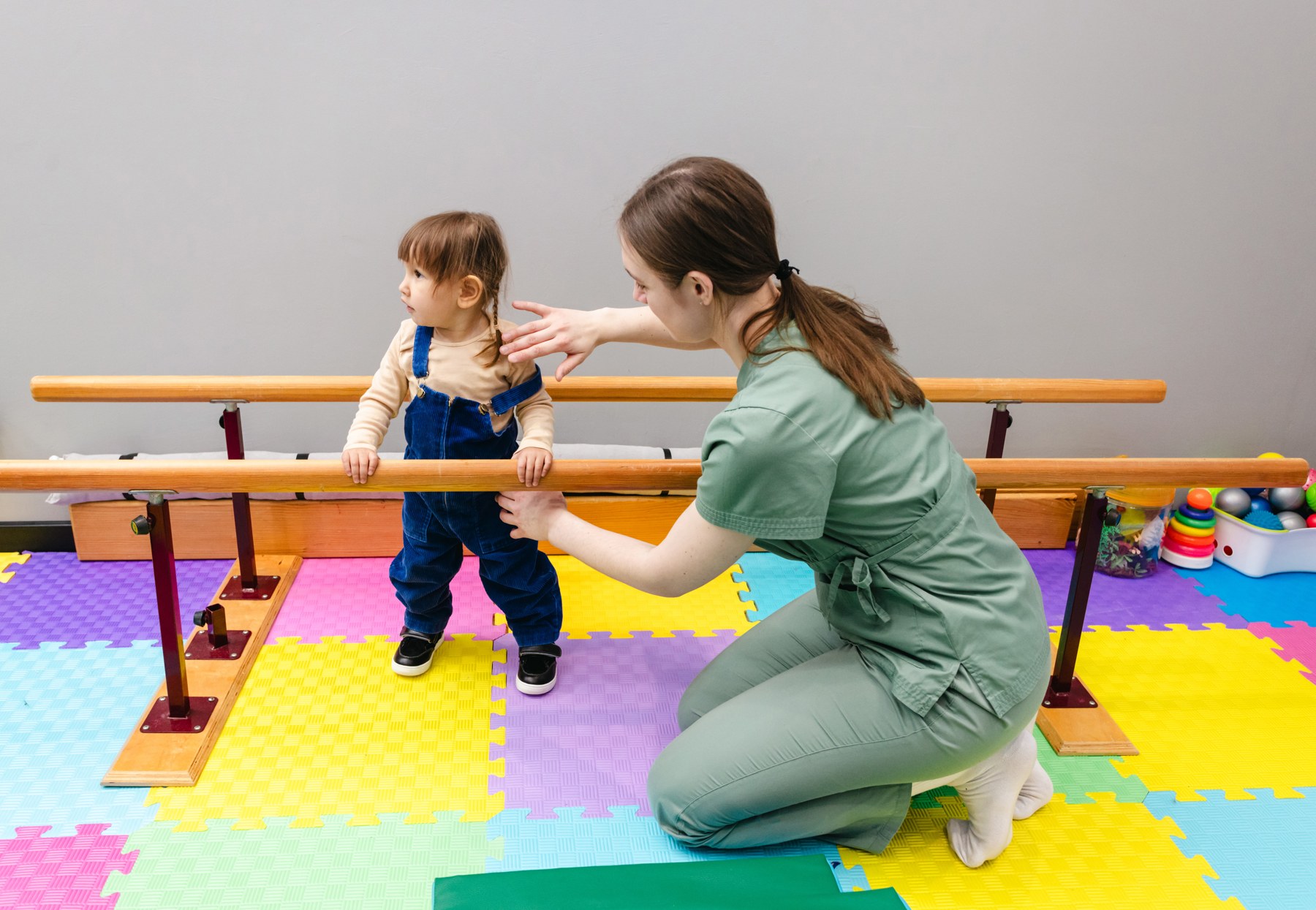 A child practising walking with a therapist